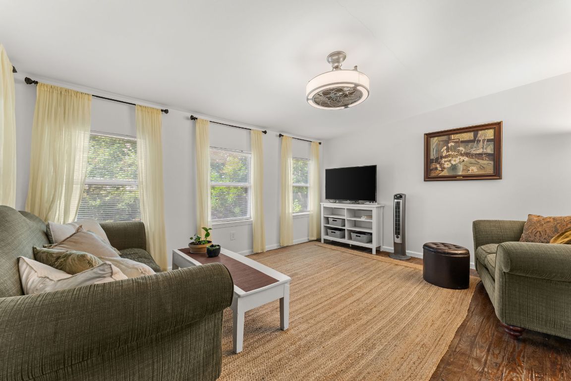 1303 Alegria Road Austin, TX 78757 - Photo 11 of 25 a living room with furniture a flat screen tv and a large window