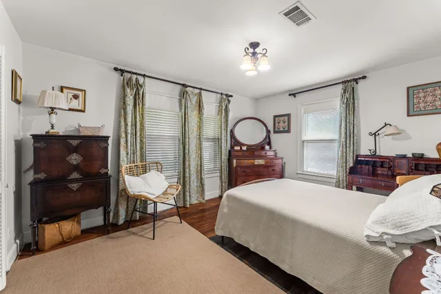 a living room with a bed furniture and a flat screen tv