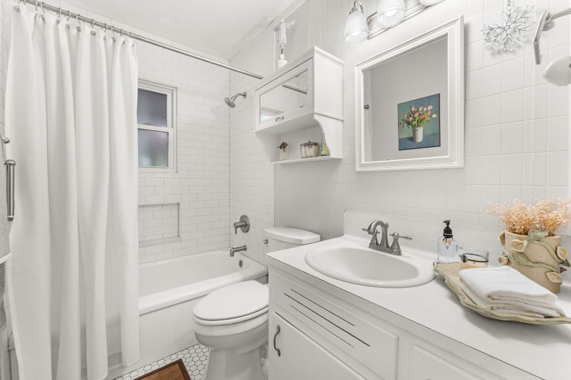 1303 Alegria Road Austin, TX 78757 - Photo 15 of 25 a bathroom with a sink toilet and shower
