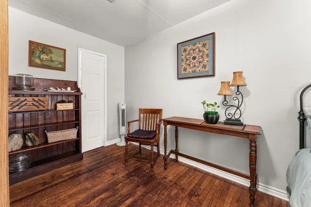 a view of a workspace with furniture and wooden floor