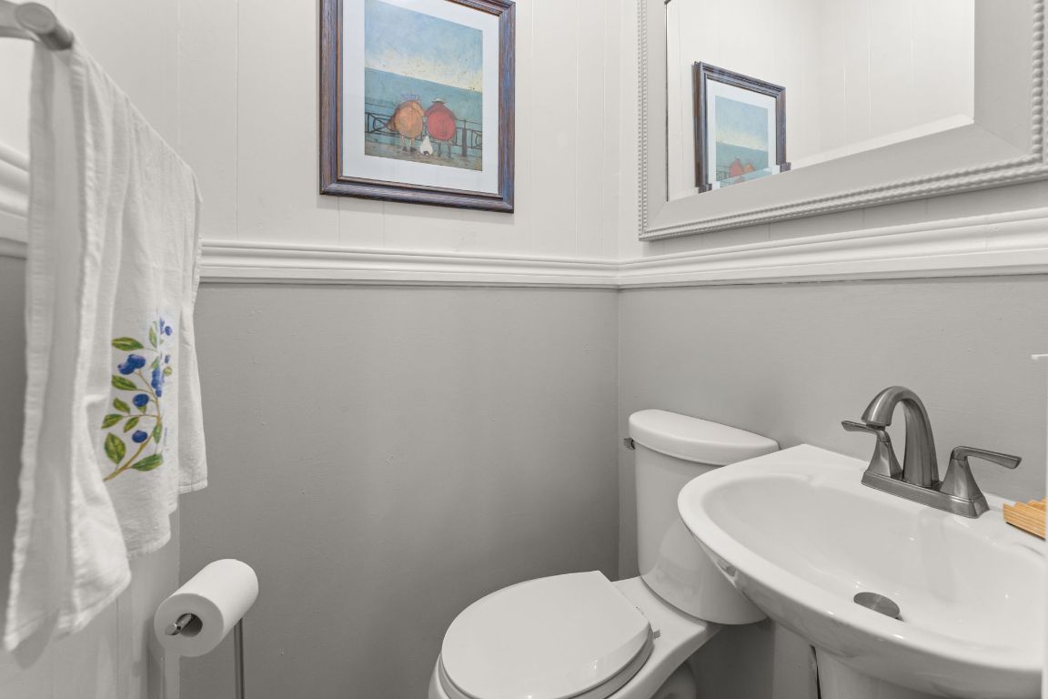 1303 Alegria Road Austin, TX 78757 - Photo 18 of 25 a bathroom with a toilet a sink and mirror