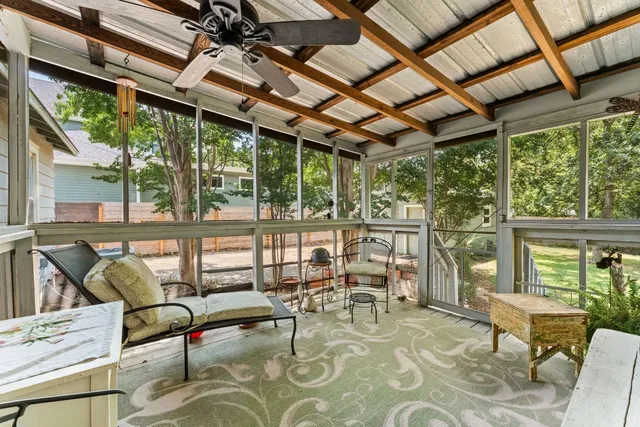 a building outdoor space with patio furniture and potted plants