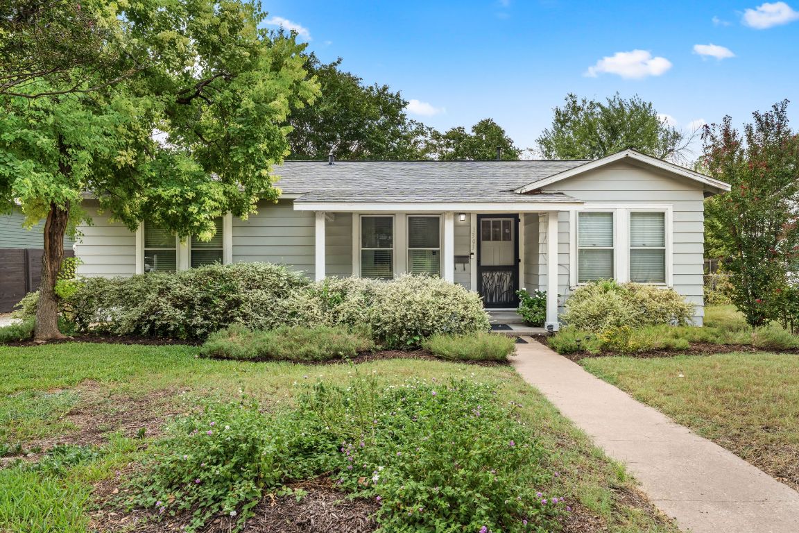1303 Alegria Road Austin, TX 78757 - Photo 2 of 25 a front view of a house with a yard