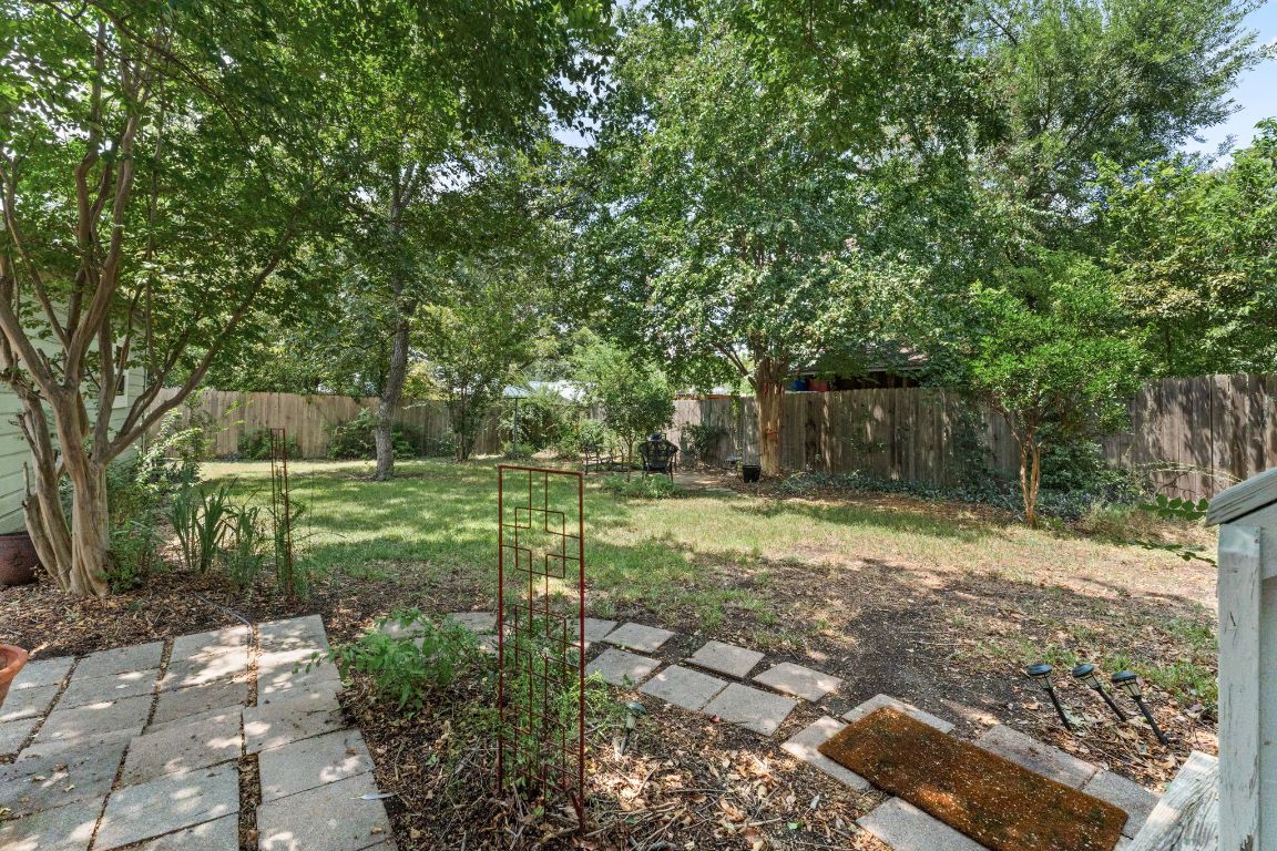 1303 Alegria Road Austin, TX 78757 - Photo 24 of 25 a view of a backyard with large trees