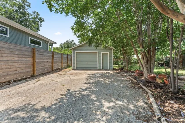 a view of a backyard with a large tree