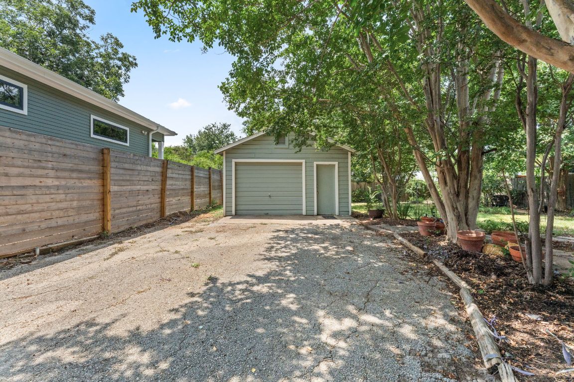 1303 Alegria Road Austin, TX 78757 - Photo 25 of 25 a view of a backyard with a large tree