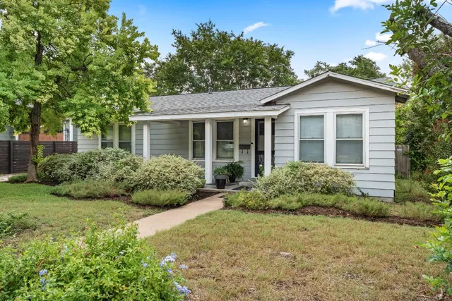 a front view of house with yard and green space
