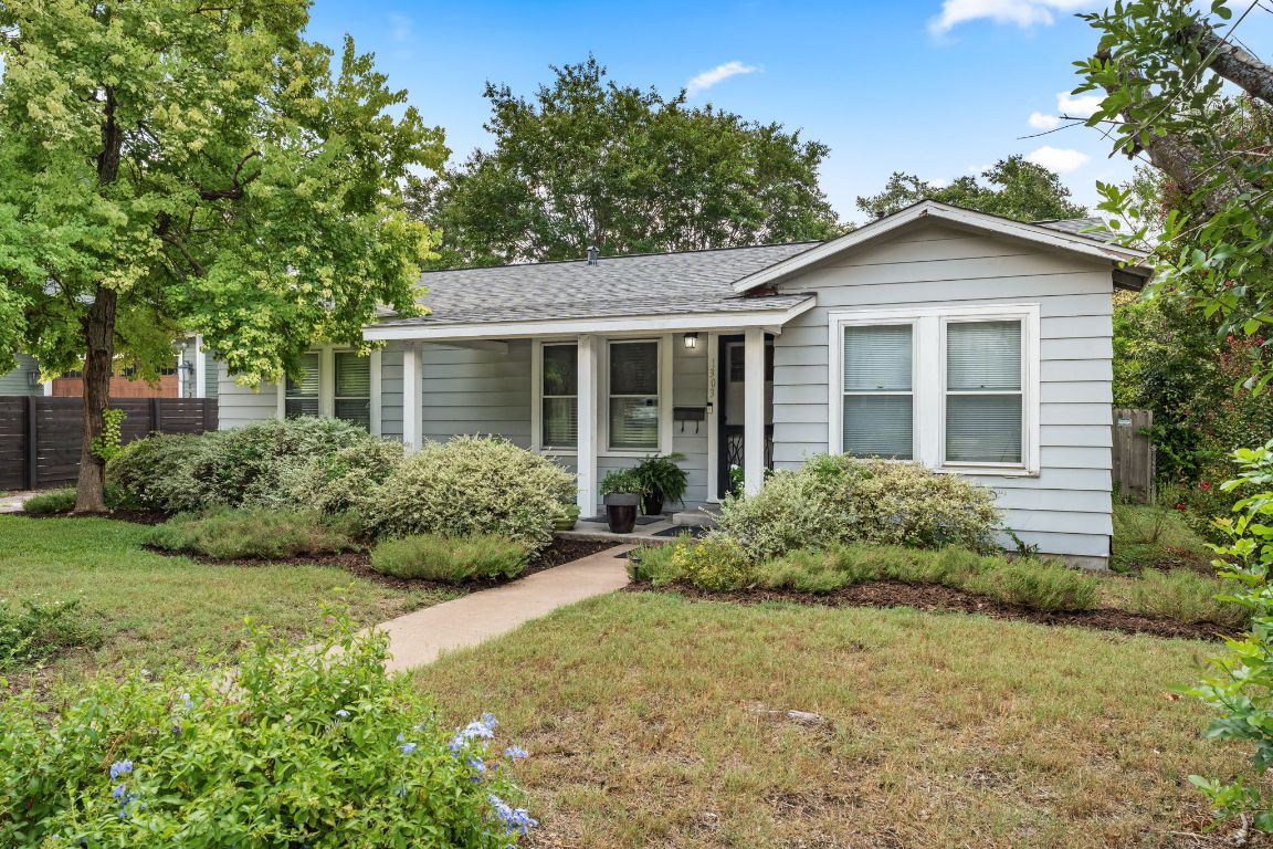1303 Alegria Road Austin, TX 78757 - Photo 3 of 25 a front view of house with yard and green space