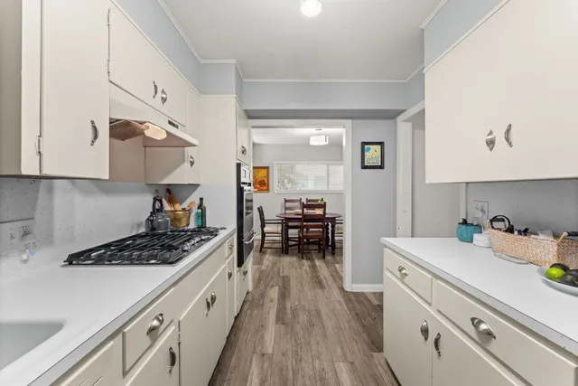 a kitchen with wooden cabinets and a stove top oven
