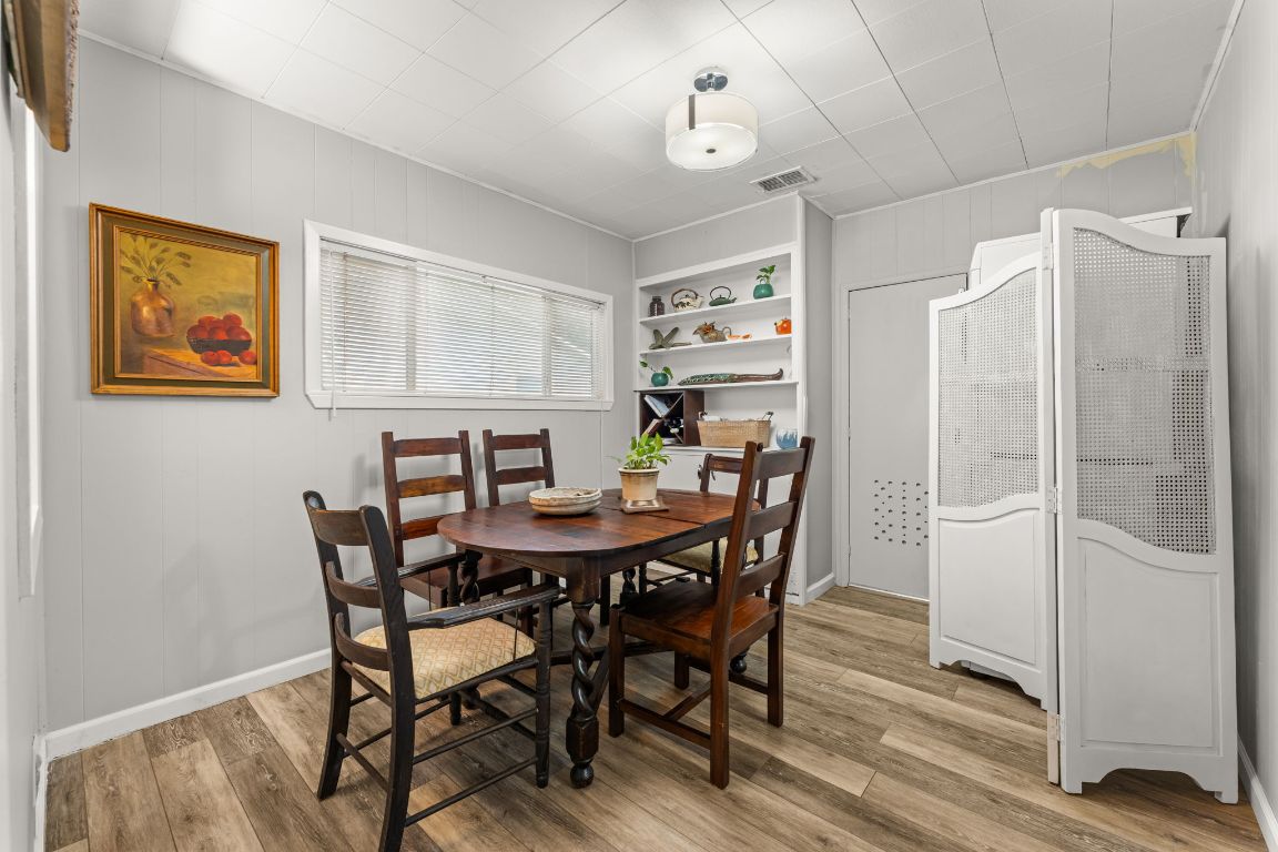1303 Alegria Road Austin, TX 78757 - Photo 10 of 25 a view of a dining room with furniture and wooden floor