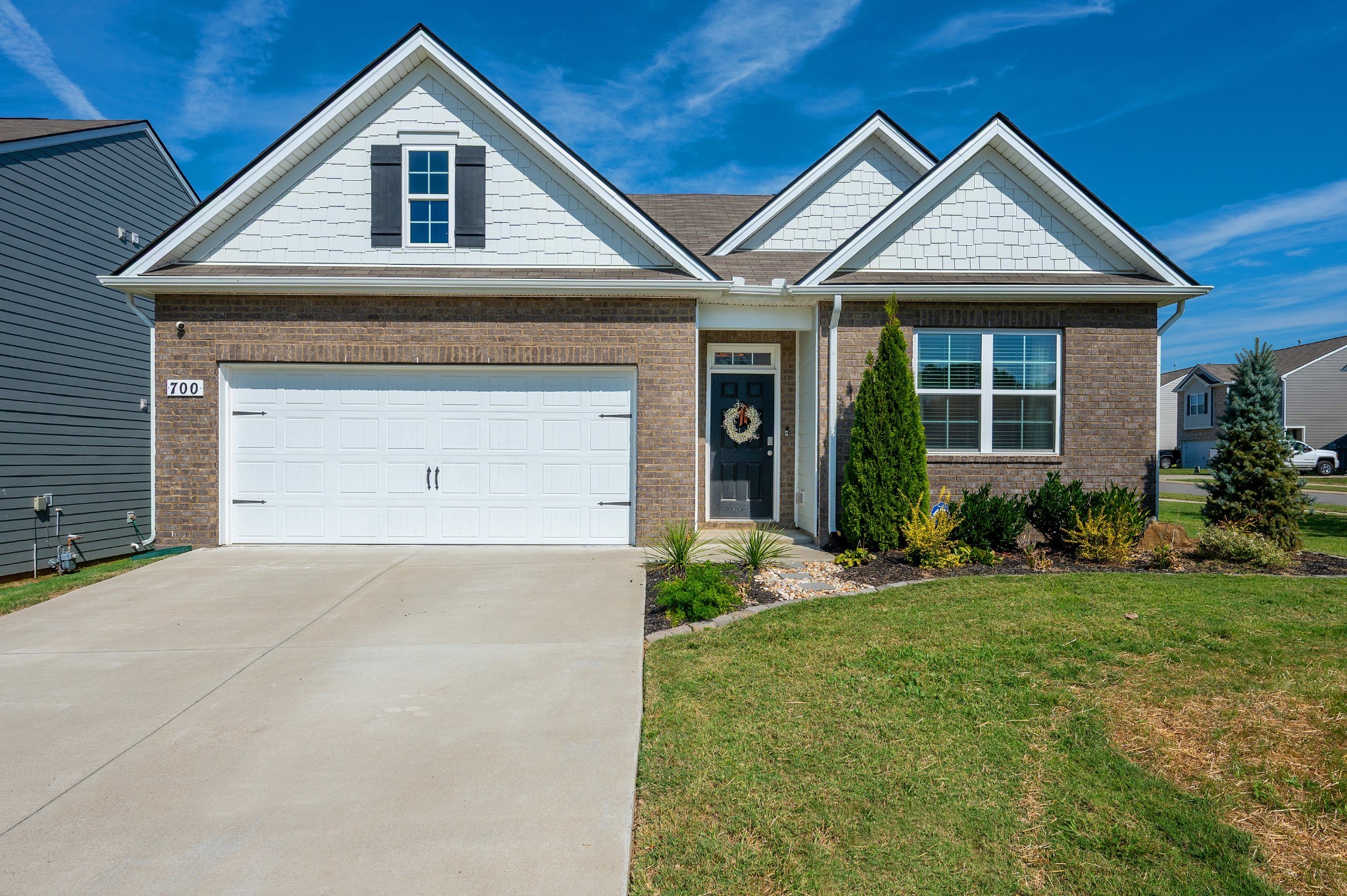 a front view of a house with a yard and garage
