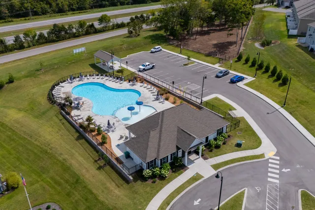 an aerial view of a house with garden space and lake view