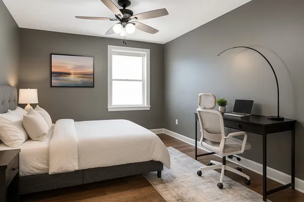 a bedroom with a bed a desk and chair