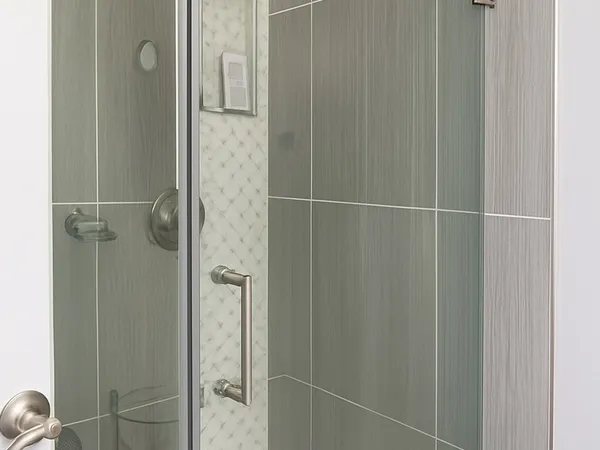 a bathroom with a glass shower door