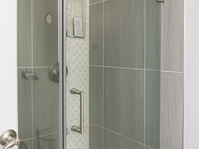a bathroom with a glass shower door