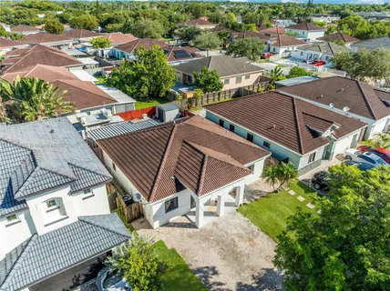 an aerial view of a houses with an outdoor space