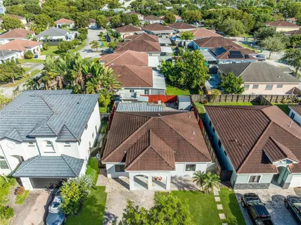 an aerial view of multiple houses with yard