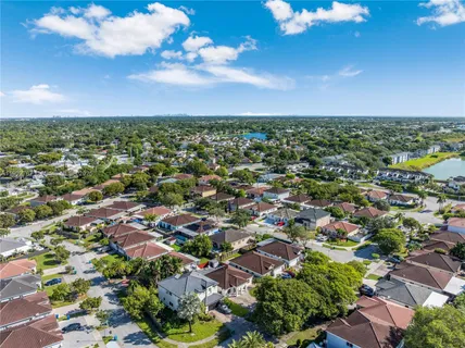 an aerial view of a houses with a yard