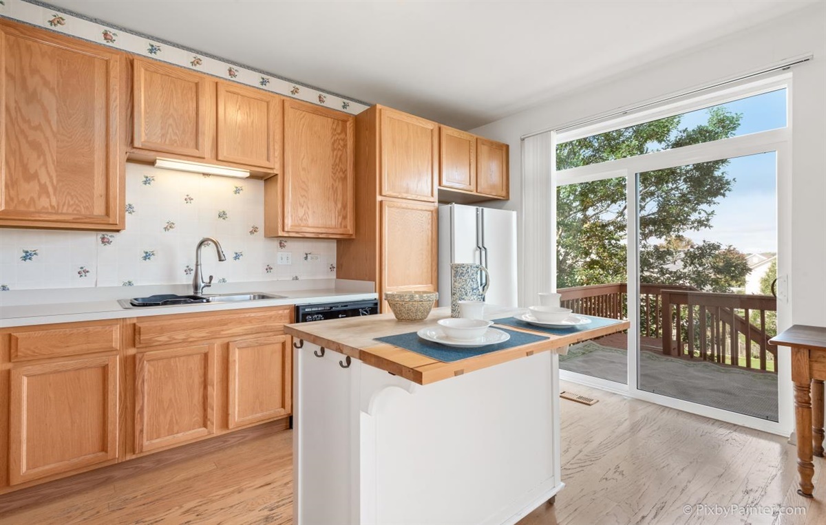 243 Grand Ridge Road St. Charles, IL 60175 - Photo 11 of 29 a kitchen with stainless steel appliances granite countertop white cabinets a sink and a large window