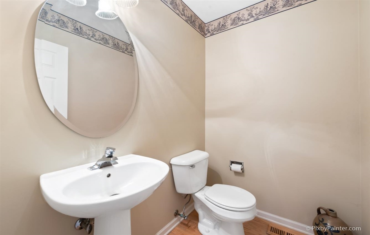 243 Grand Ridge Road St. Charles, IL 60175 - Photo 16 of 29 a bathroom with a sink a mirror and a toilet