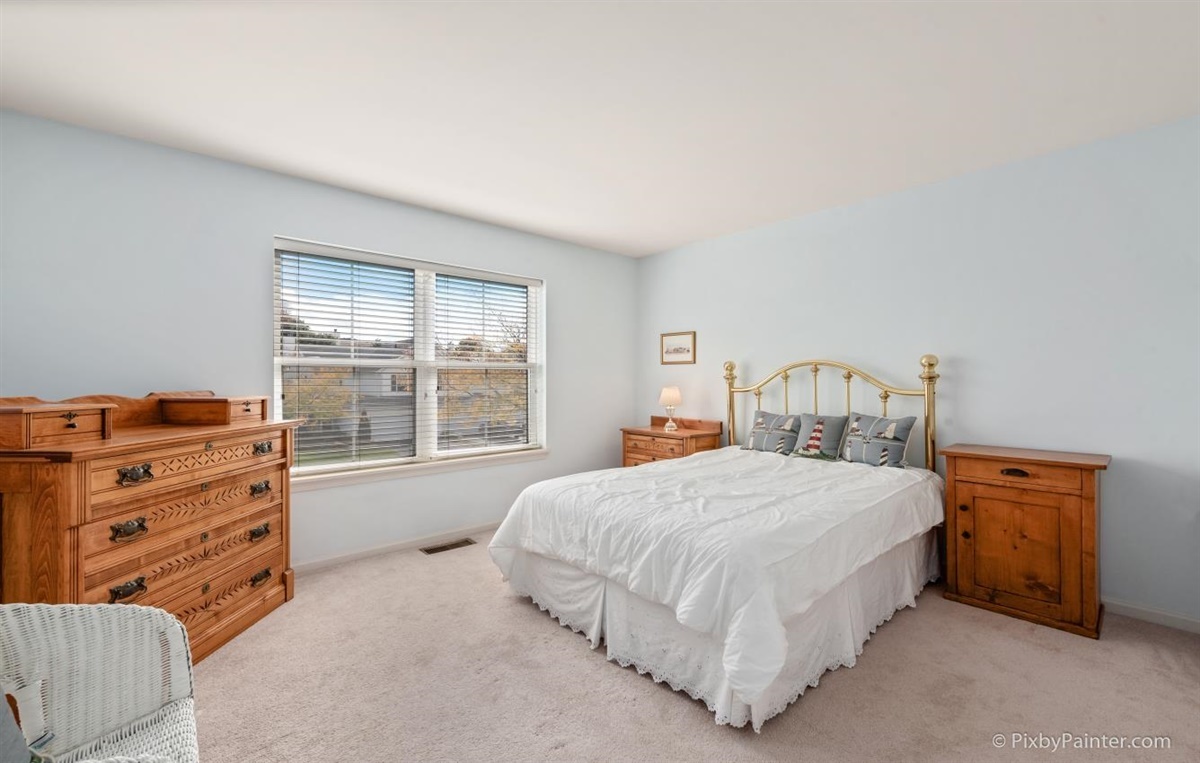 243 Grand Ridge Road St. Charles, IL 60175 - Photo 20 of 29 a bedroom with a bed and a dresser next to a window