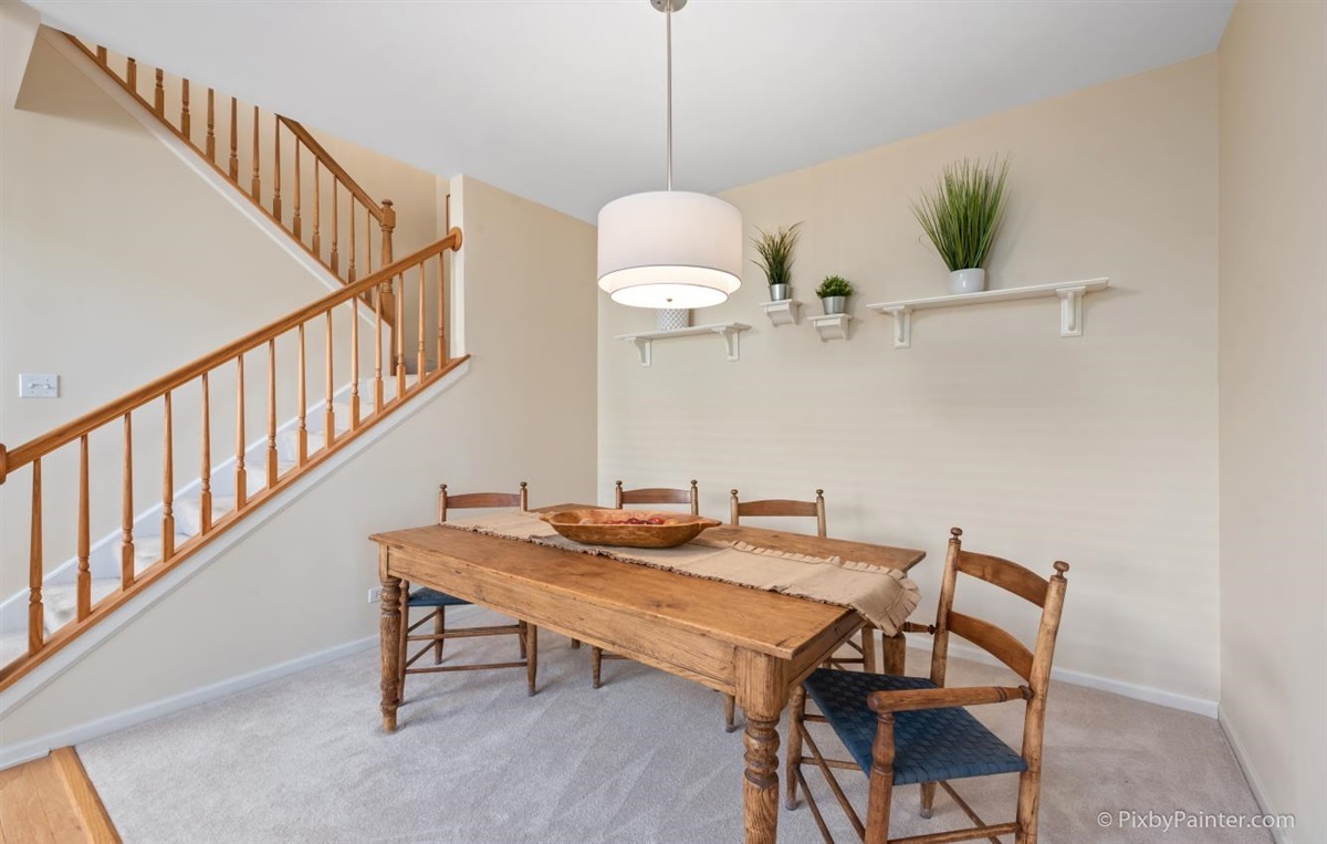 243 Grand Ridge Road St. Charles, IL 60175 - Photo 6 of 29 a dining room with wooden floor a chandelier a wooden table and chairs