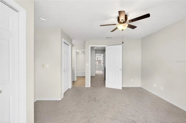 a view of a livingroom with a ceiling fan and window