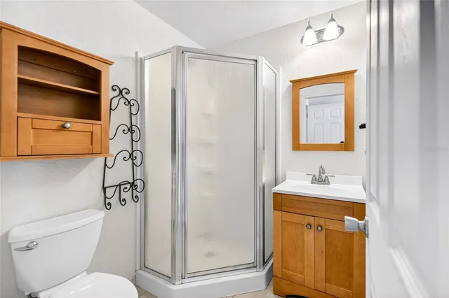 a bathroom with a toilet a sink and a shower