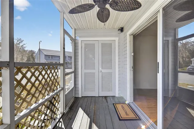 an empty room with a ceiling fan and a window