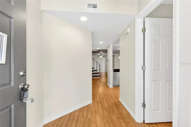a view of a hallway with wooden floor