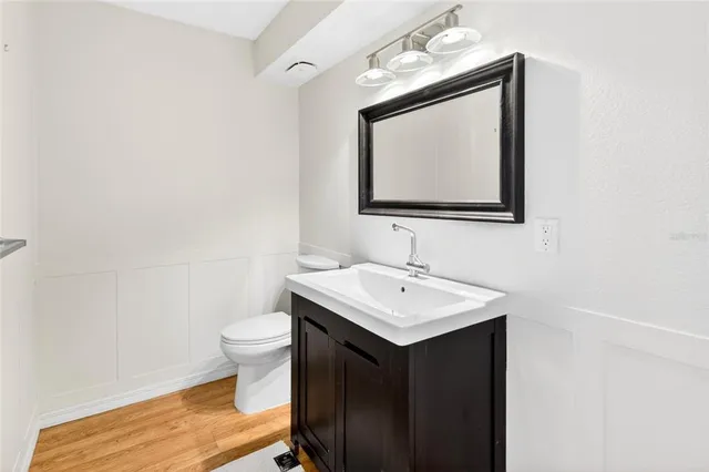 a bathroom with a toilet sink and mirror