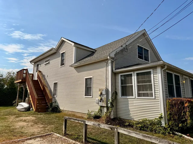 a view of a house with a wooden fence