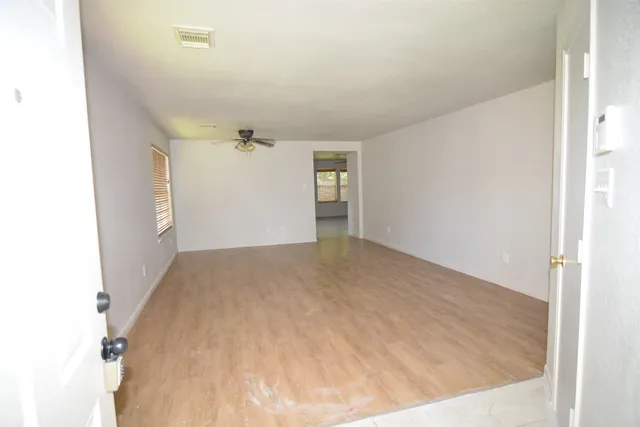 a view of a big room with closet and windows