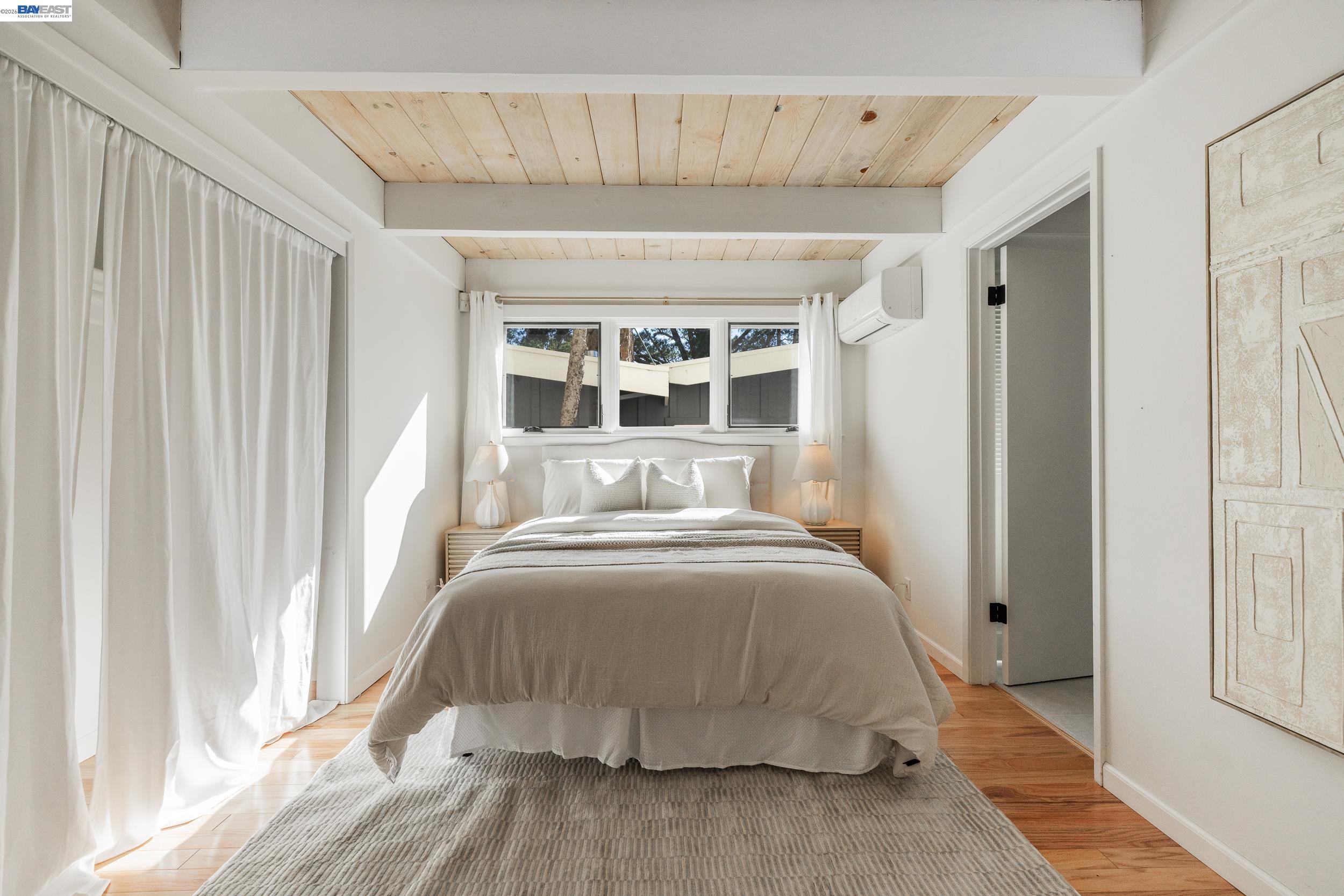 148 Ridgeway Avenue Fairfax, CA 94930 - Photo 13 of 31 a spacious bedroom with a bed and a window