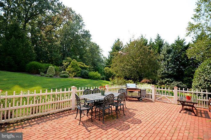 18600 Gunpowder Road Hampstead, MD 21074 - Photo 3 of 21 a view of a patio with table and chairs floor to ceiling window with wooden fence