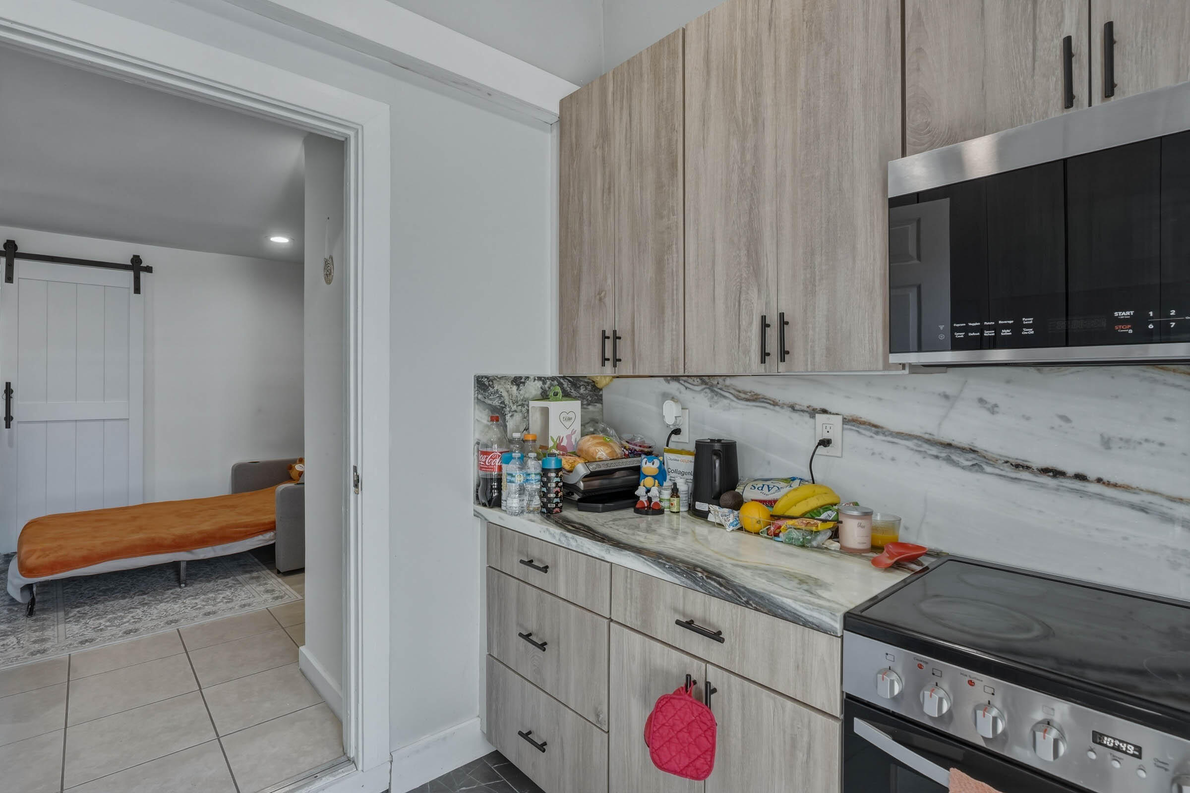 2805 Flagler Avenue Key West, FL 33040 - Photo 16 of 53 a kitchen with stainless steel appliances a stove a microwave and cabinets