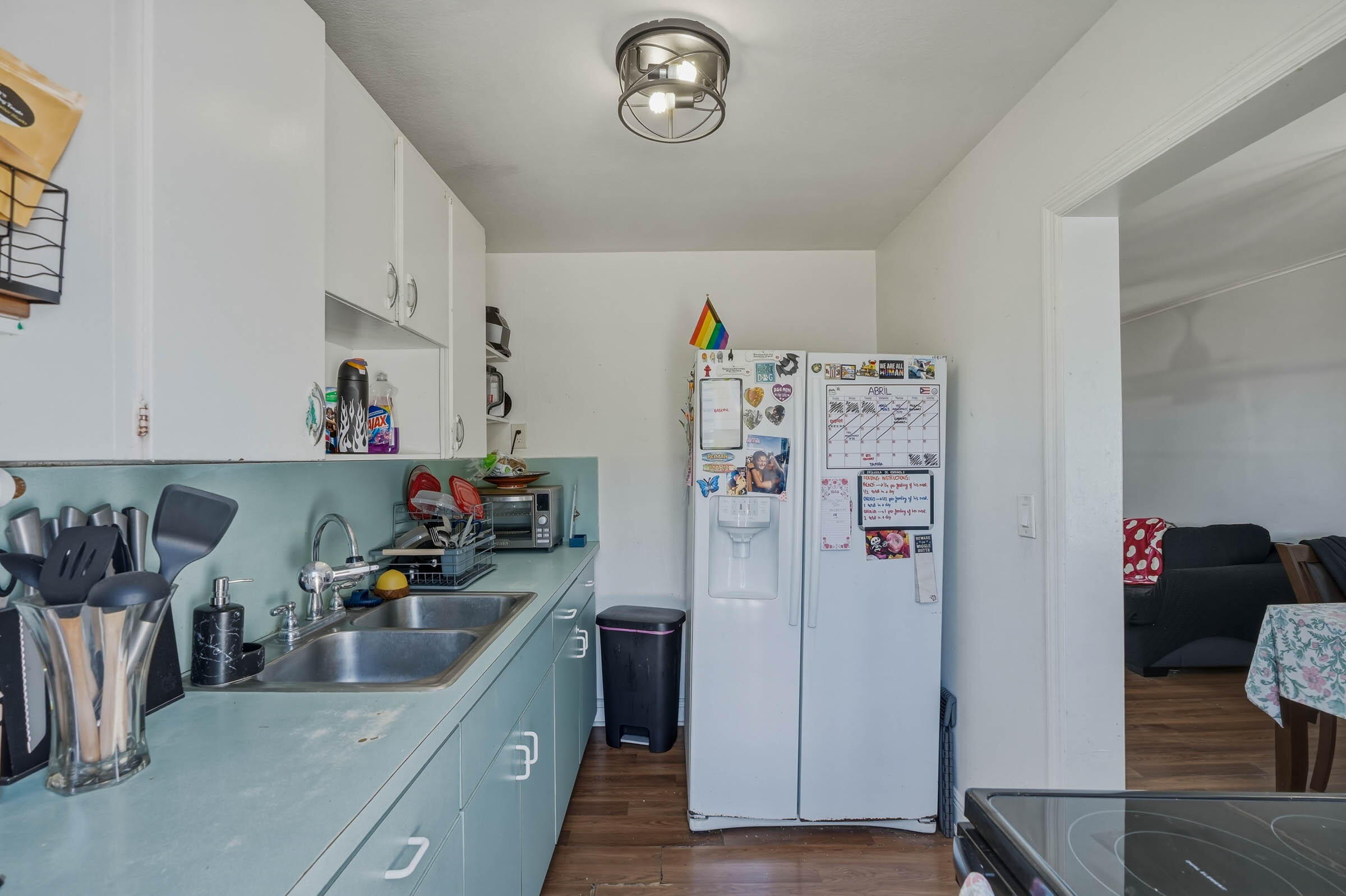 2805 Flagler Avenue Key West, FL 33040 - Photo 35 of 53 a kitchen with refrigerator a microwave a stove and wooden floor