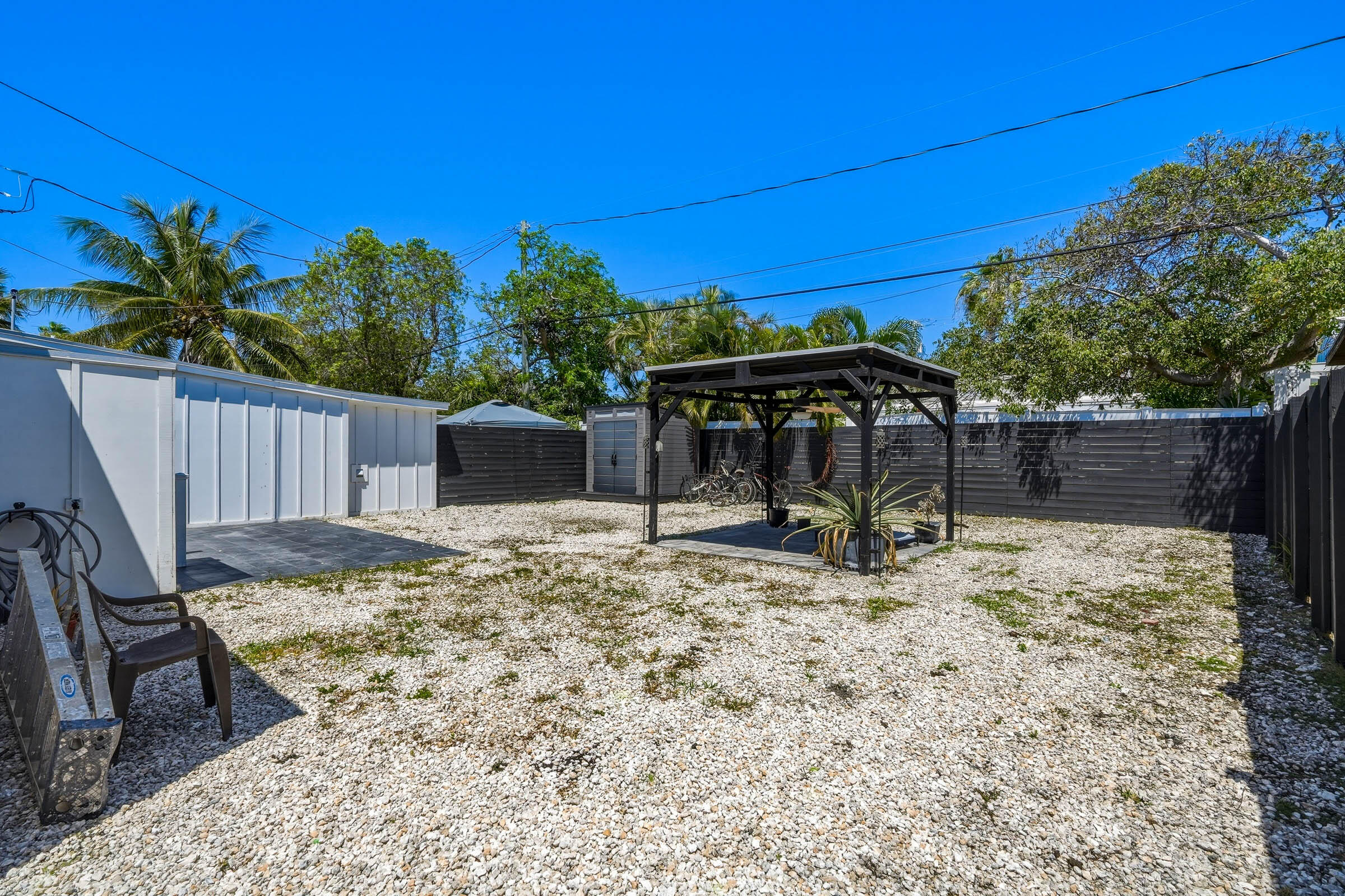 2805 Flagler Avenue Key West, FL 33040 - Photo 47 of 53 a view of a backyard with a table and chairs under an umbrella