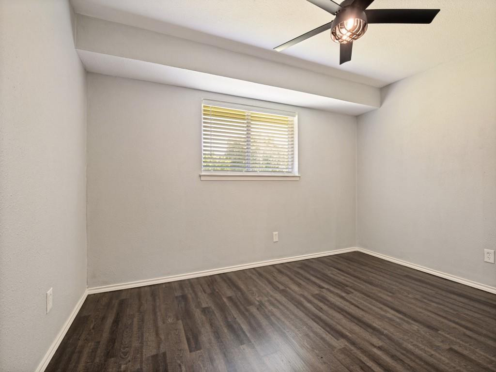 1405 Rambler Road Arlington, TX 76014 - Photo 20 of 26 Interior room featuring wood-finish flooring, light gray walls, and white baseboards