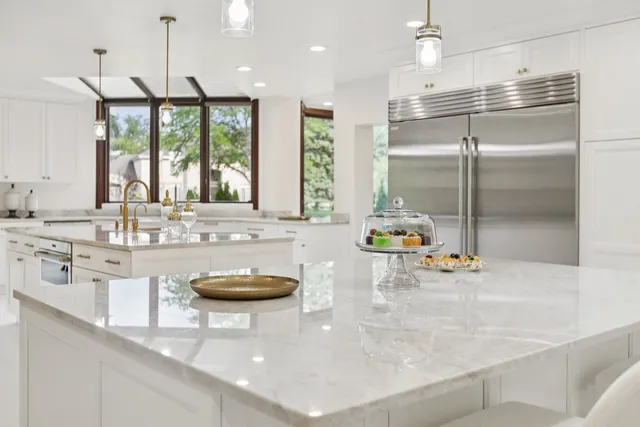 a living room with a window and potted plants