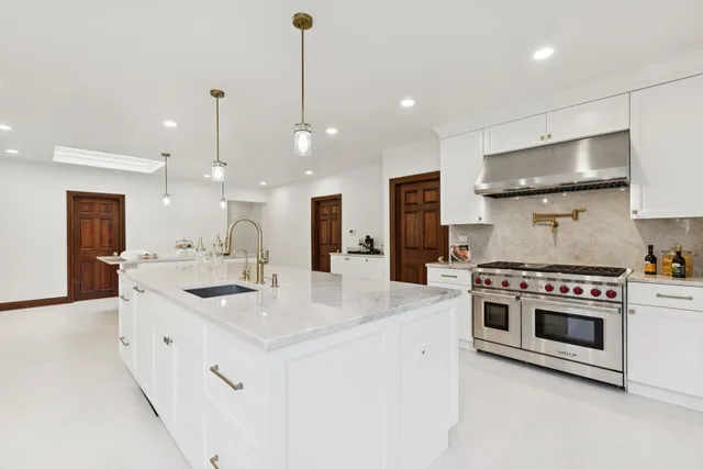 a dining room with furniture water view and a large window