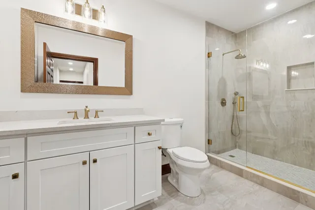 a view of staircase with railing and white walls