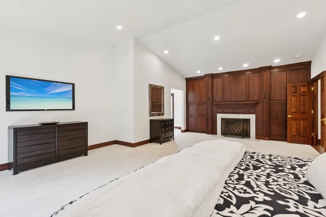 a bedroom with a bed and a fireplace