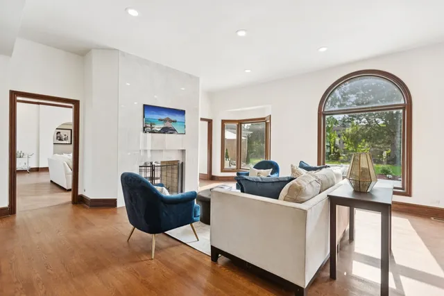 a view of a dining room with furniture a chandelier and wooden floor