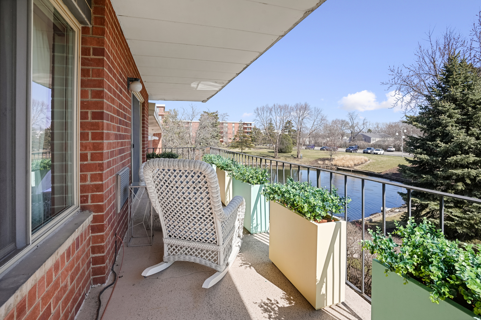 16 East Old Willow Road, Unit 223S Prospect Heights, IL 60070 - Photo 14 of 27 a view of a balcony with wooden chairs and floor to ceiling window