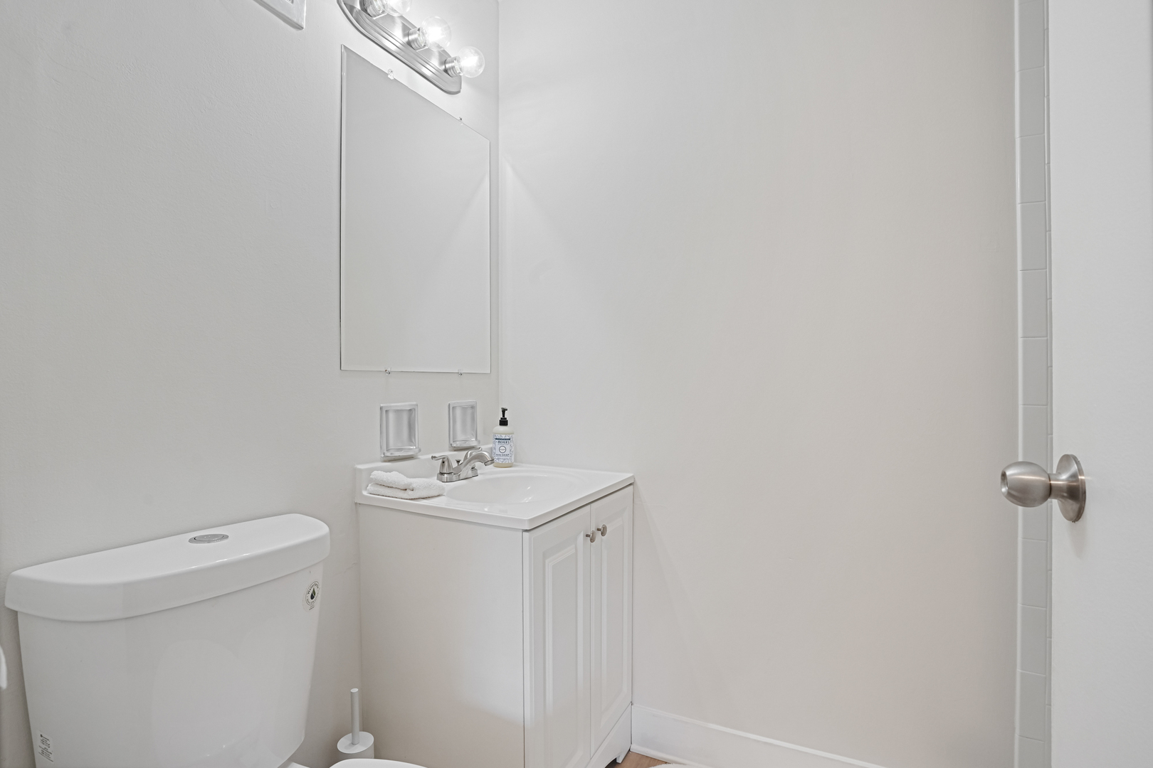 16 East Old Willow Road, Unit 223S Prospect Heights, IL 60070 - Photo 10 of 27 a bathroom with a sink a toilet and a mirror