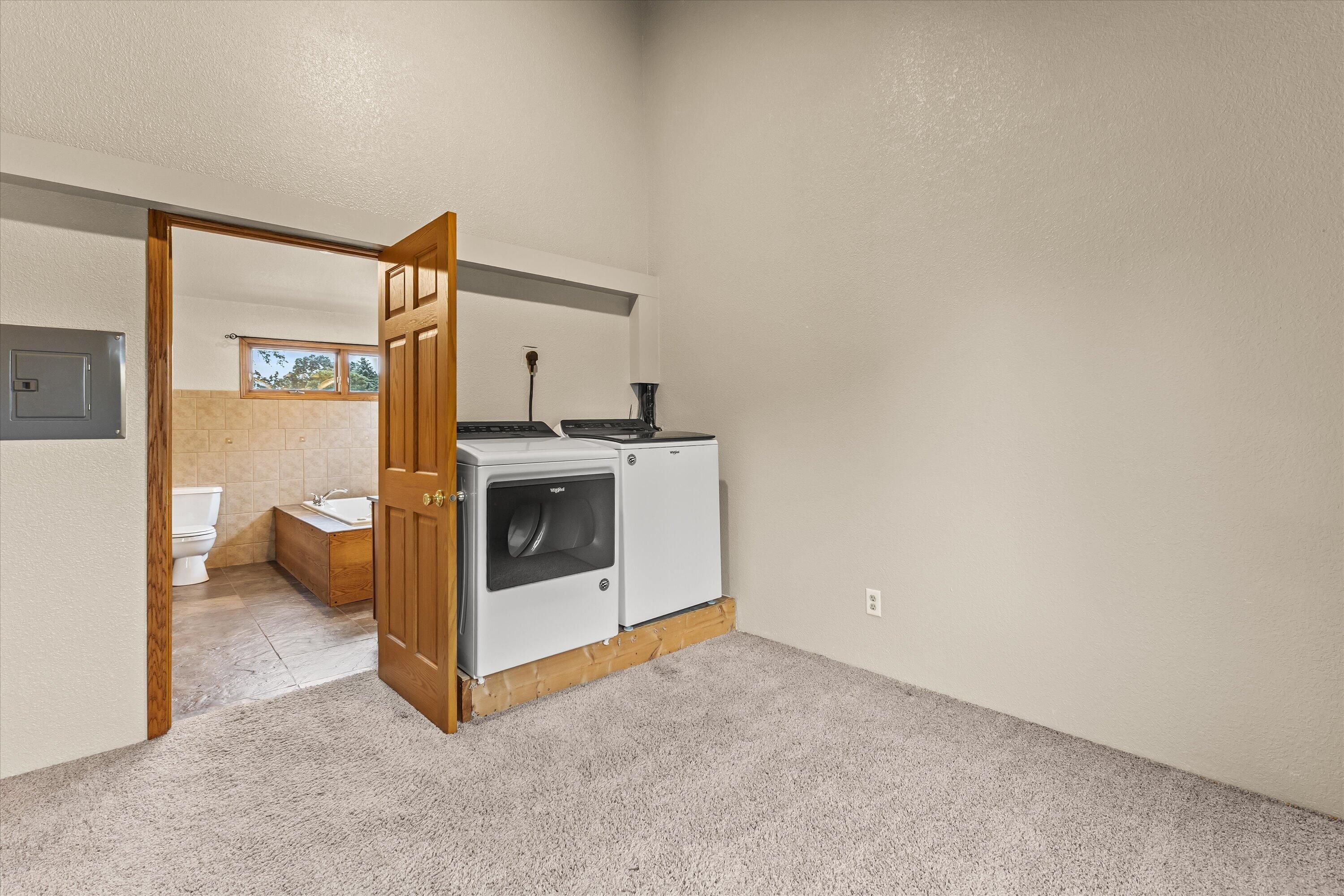 2925 North Main Street Racine, WI 53402 - Photo 21 of 23 Laundry is thoughtfully located adjacent to the primary suite, adding convenience and functionality to everyday living.