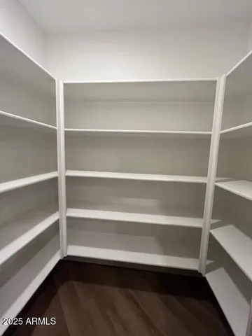 a view of walk in closet with empty racks