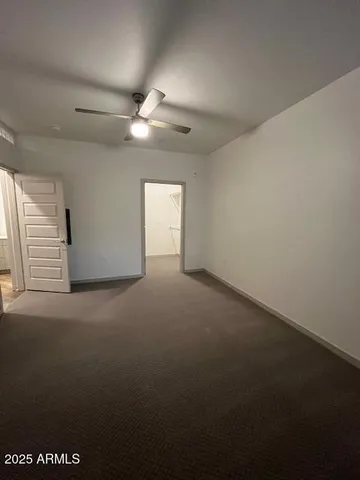 a view of empty room with ceiling fan
