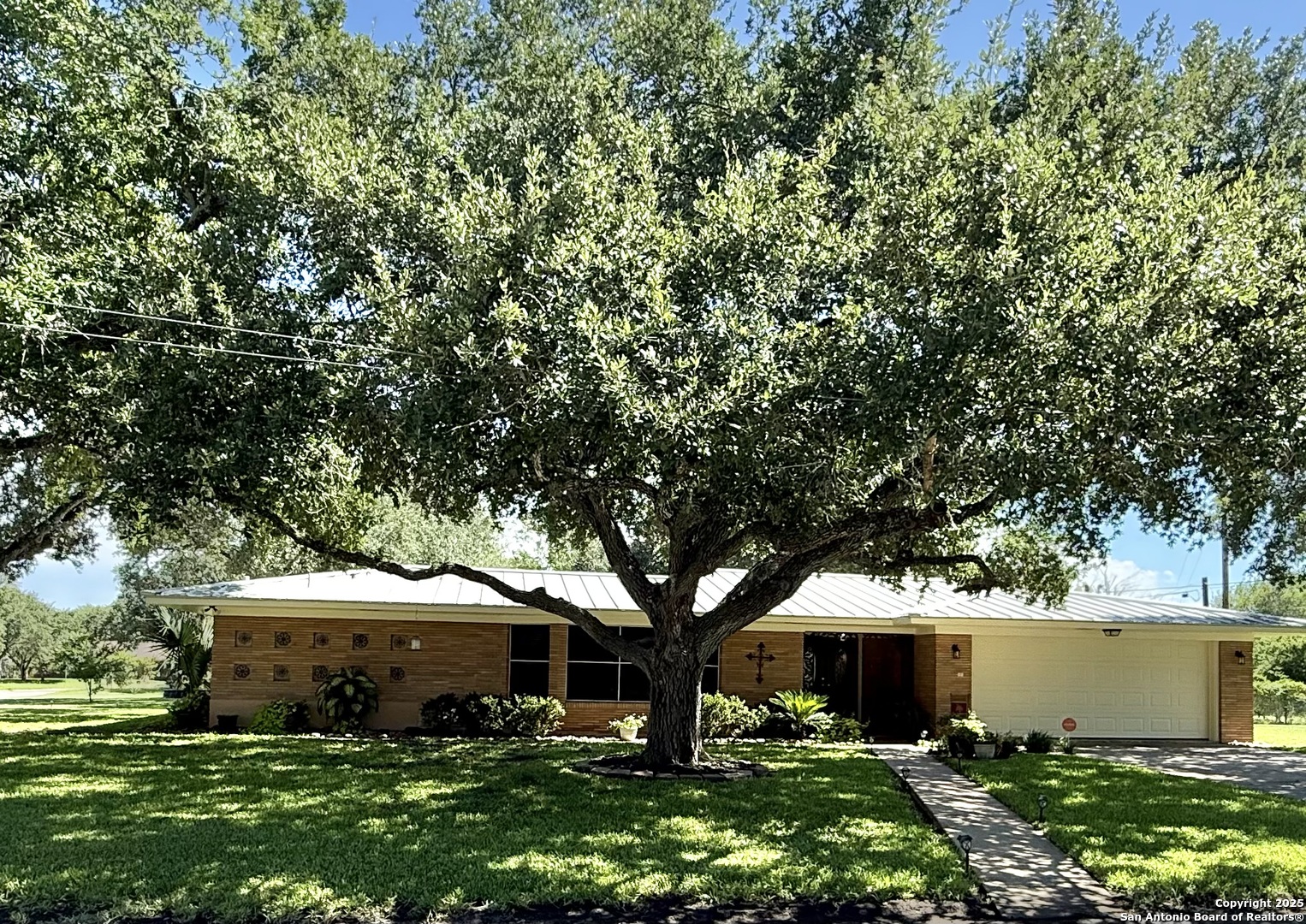 a front view of a house with garden